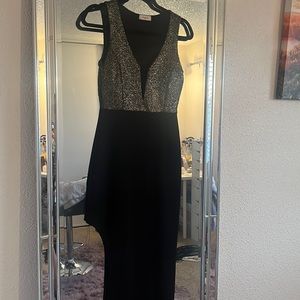 Sparkly gold top going into a long black dress with slit on the side